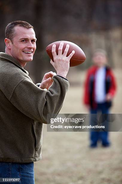 father son outdoor football - editorial process stock pictures, royalty-free photos & images