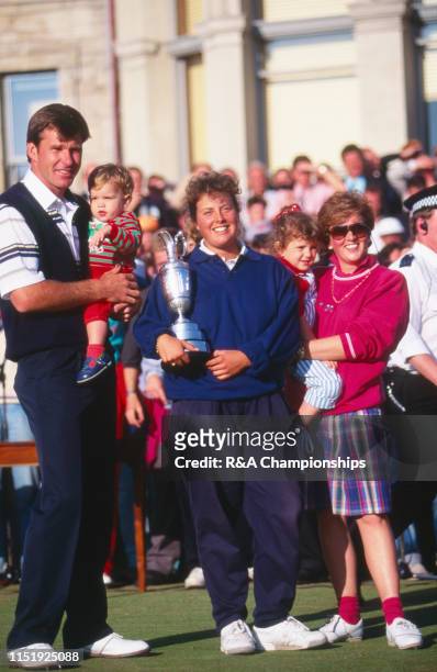 Nick Faldo of England poses with wife Gill Faldo and caddie Fanny Suneson after his victory during The 119th Open Championship held on the Old Course...