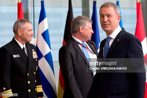 Turkey's Defense Minister Hulusi Akar looks on as he arrives for a meeting of NATO defense ministers at NATO headquarters in Brussels, on June 26,...
