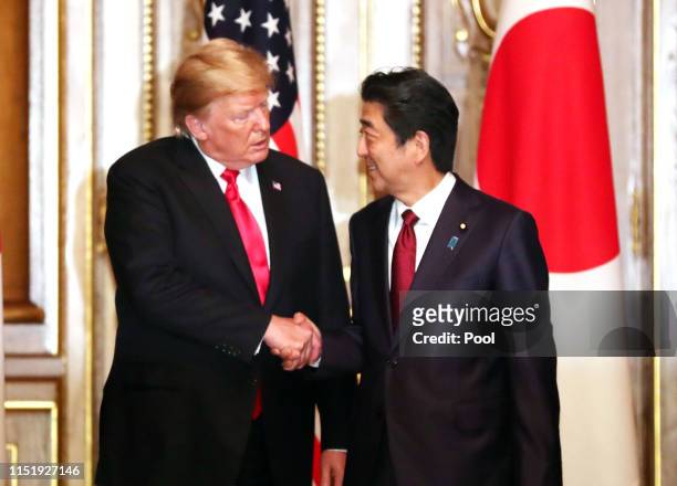 President Donald Trump shakes hands with Japanese Prime Minister Shinzo Abe prior to their working luncheon at the Akasaka guesthouse in Tokyo on May...