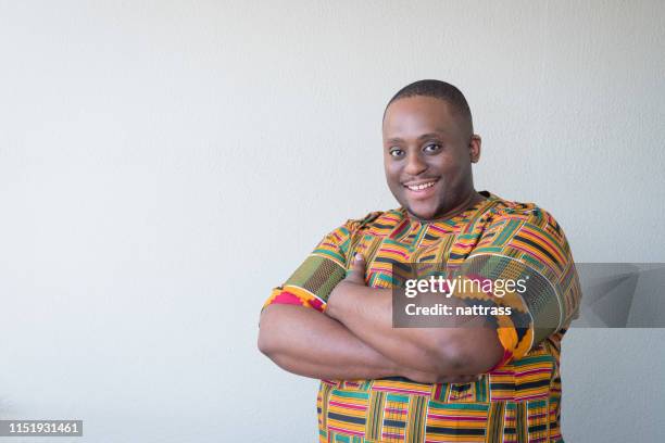 portrait of overweight man in traditional clothing - african tradition stock pictures, royalty-free photos & images