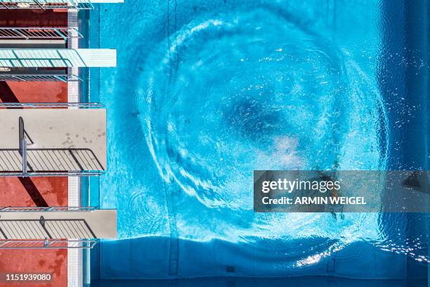 Man dives in an open air public pool in Straubing, southern Germany, where temperatures reached up to 34 degrees Celsius on June 26, 2019....