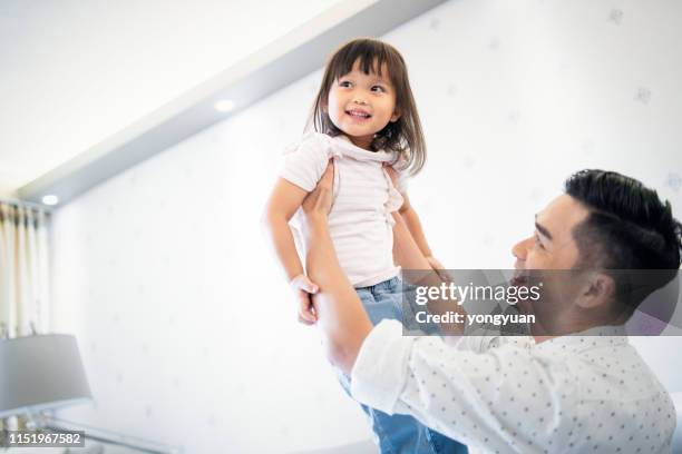 happy chinese father lifting up his daughter - yongyuan hongkong stock pictures, royalty-free photos & images