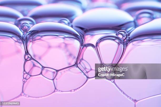 pink colored soap foam macro photography - foam material stockfoto's en -beelden