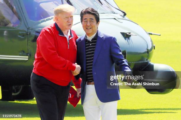 President Donald Trump is welcomed by Japanese Prime Minister Shinzo Abe prior to playing golf at Mobara Country Club on May 26, 2019 in Mobara,...