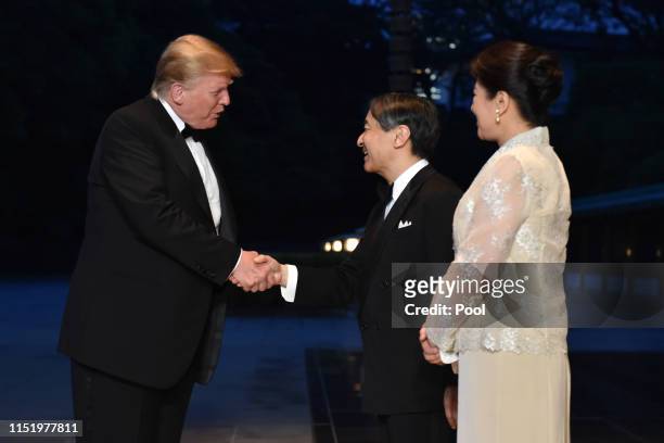 President Donald Trump is greeted by Japan's Emperor Naruhito and Empress Masako upon his arrival at the Imperial Palace for a state banquet on May...