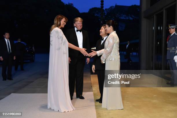 President Donald Trump and First Lady Melania Trump are greeted by Japan's Emperor Naruhito and Empress Masako upon their arrival at the Imperial...