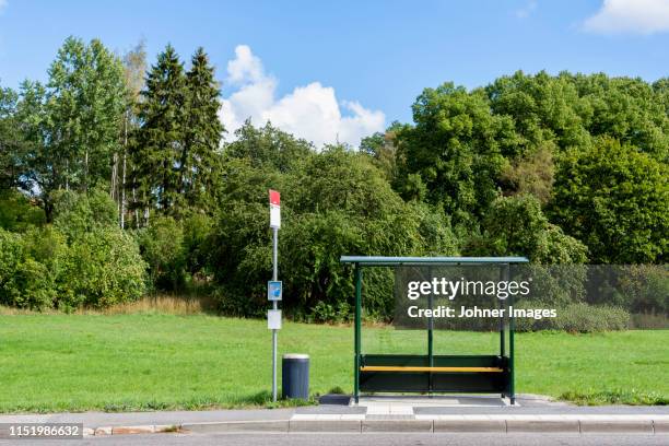 empty bus stop by forest - bus stop stock pictures, royalty-free photos & images