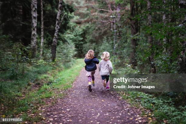 girls running in forest - lane sisters ストックフォトと画像