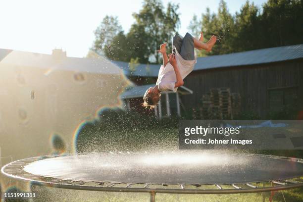 boy jumping on trampoline - trampoline stock pictures, royalty-free photos & images