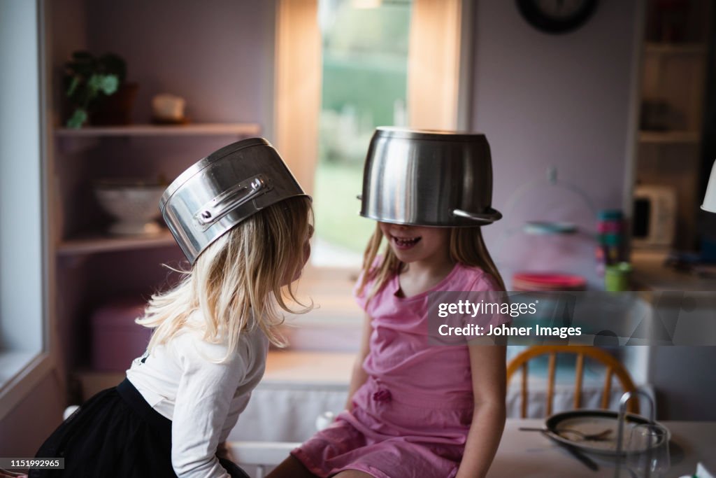 Girls wearing pots