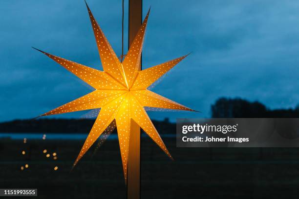 illuminated christmas star - poinsettia stock pictures, royalty-free photos & images