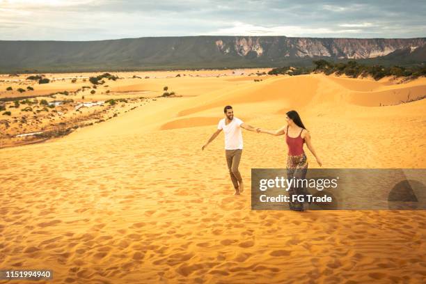 couple walking in the sand dunes of jalapão, tocantins - tocantins stock pictures, royalty-free photos & images