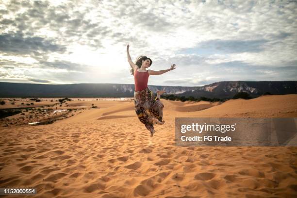 woman jumping in the sand dunes of jalapão state park, tocantinswoman jumping in the sand dunes of jalapão state park, tocantins - tocantins stock pictures, royalty-free photos & images