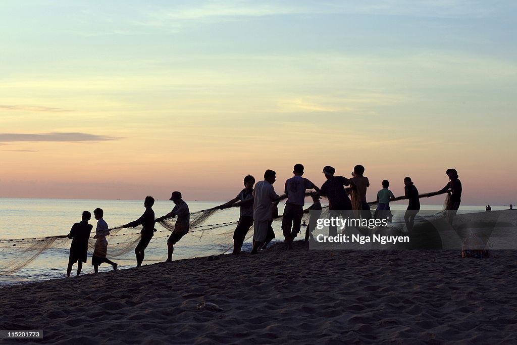 Fishermen pulling fishing net