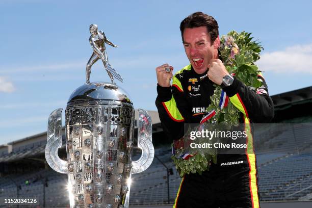 Simon Pagenaud of France, driver of the Team Penske Chevrolet poses with the Borg-Warner Trophy during the Winner's Portraits session after the 103rd...