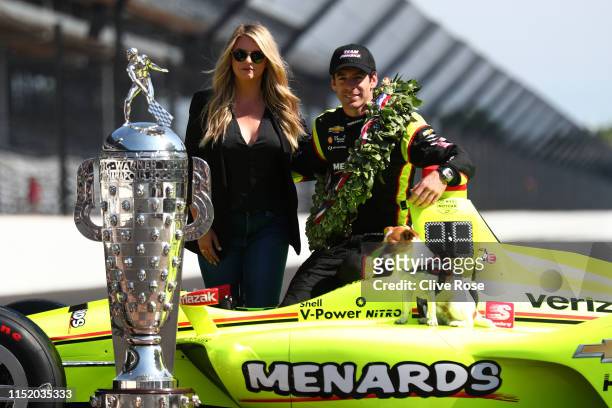 Simon Pagenaud of France, driver of the Team Penske Chevrolet poses with his Wife Hailey McDermott during the Winner's Portraits session after the...
