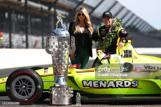 Simon Pagenaud of France, driver of the Team Penske Chevrolet poses with his Wife Hailey McDermott during the Winner's Portraits session after the...