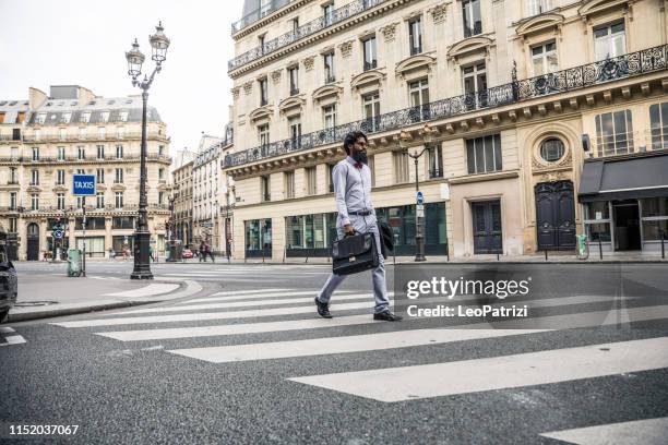 man commuting to work in the city of paris - pedestrian crossing man stock pictures, royalty-free photos & images