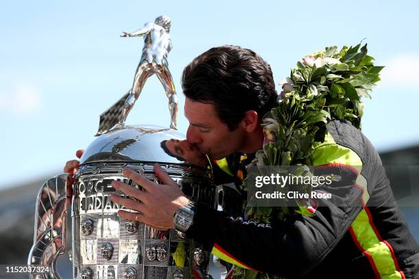 Simon Pagenaud of France, driver of the Team Penske Chevrolet hugs the Borg-Warner Trophy during the Winner's Portraits session after the 103rd...