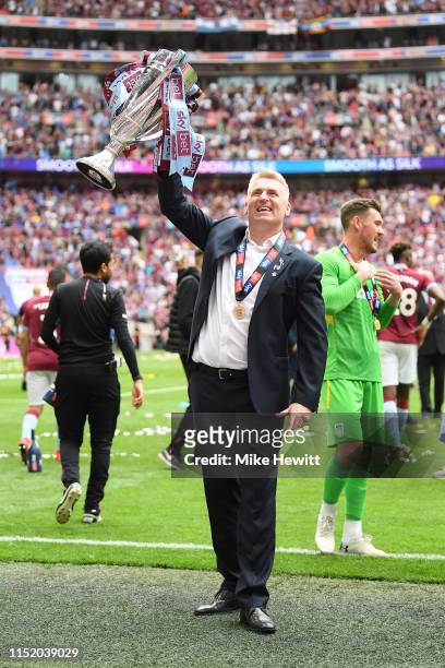 Dean Smith, Manager of Aston Villa celebrates with the trophy following victory in the Sky Bet Championship Play-off Final match between Aston Villa...