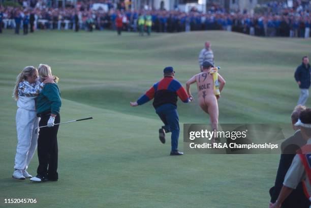 John Daly of the United States and his wife Paulette react following his victory as a Streaker runs across the 18th green during The 124th Open...