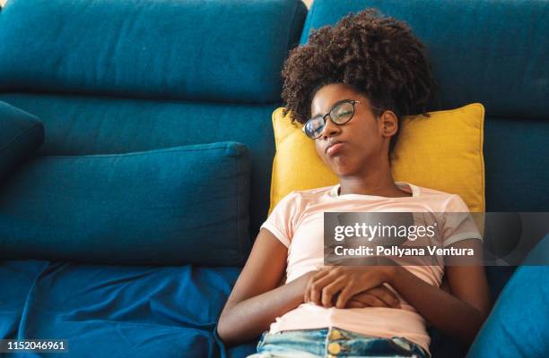 teenage girl sleeping on sofa - lying on back girl on the sofa stock pictures, royalty-free photos & images