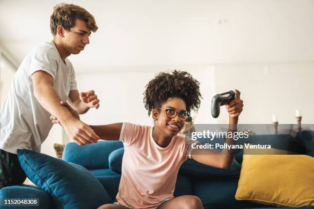 teenagers fighting and playing video game - teen fight stock pictures, royalty-free photos & images