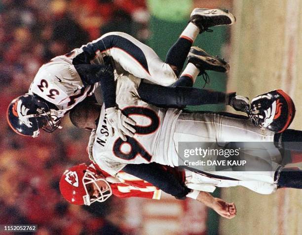 Denver Broncos player Dedrick Dodge celebrates with teammate Neil Smith after Kansas City Chiefs quarterback Elvis Grbac's pass fell incomplete in...