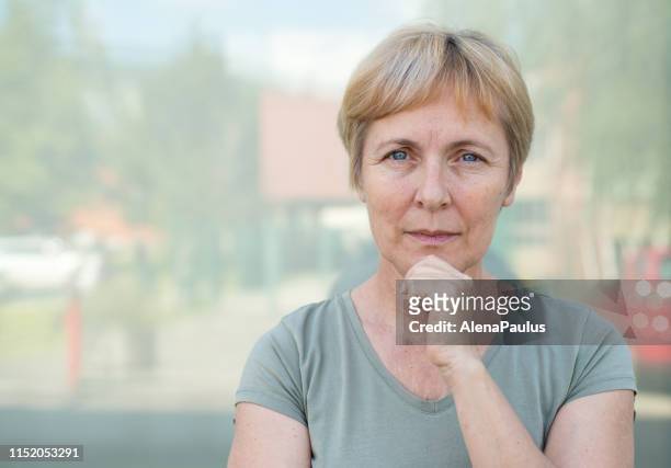 independent senior woman with short hair portrait outdoors - 50 59 years stock pictures, royalty-free photos & images