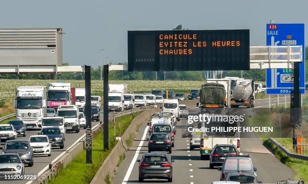 Digital display reads 'Heatwave - avoid the hot hours' on the A25 motorway in Lille, northern France, on June 26, 2019. Meteorologists blamed a blast...