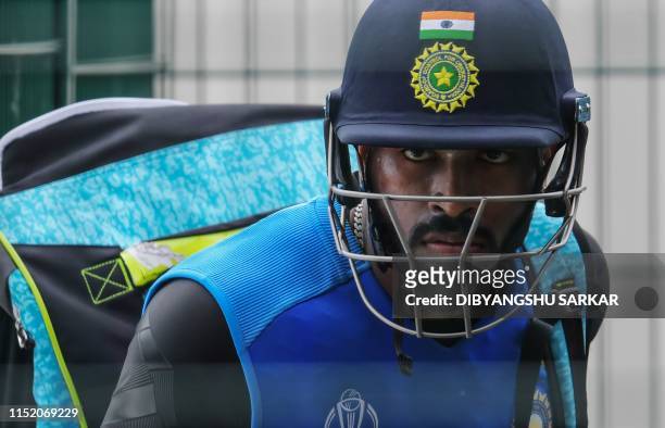 India's Hardik Pandya arrives with his equipment ahead of a training session at Old Trafford in Manchester, northwest England on June 26 ahead of...