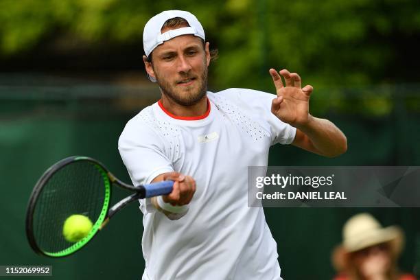 France's Lucas Pouille returns to Japan's Kei Nishikori during a men's exhibition singles match at The Aspall Tennis Classic tournament at the...