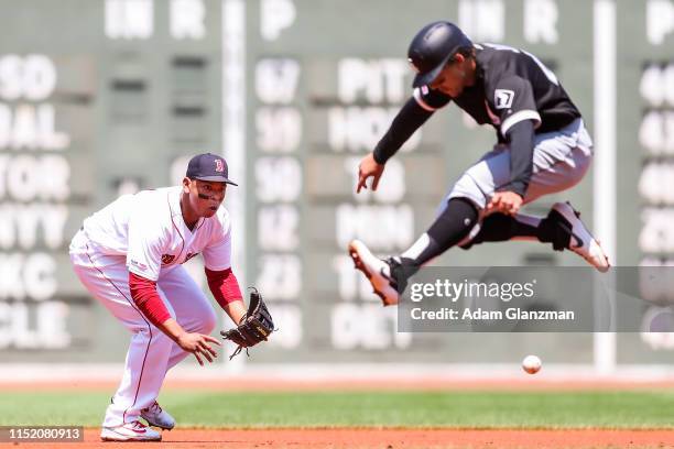 Leury Garcia of the Chicago White Sox jumps out of the way as Rafael Devers of the Boston Red Sox fields a ground ball in the first inning of a game...