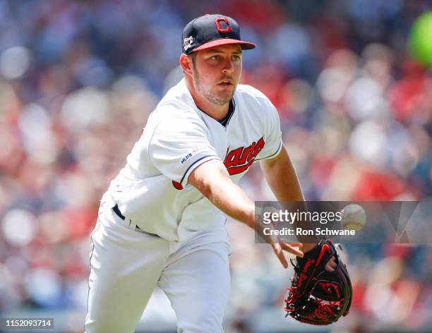 Starting pitcher Trevor Bauer of the Cleveland Indians throws out Whit Merrifield of the Kansas City Royals at first base during the fifth inning at...