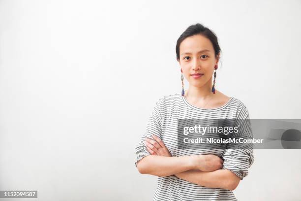 young millennial asian female artist confident portrait arms crossed - asian woman short hair stock pictures, royalty-free photos & images