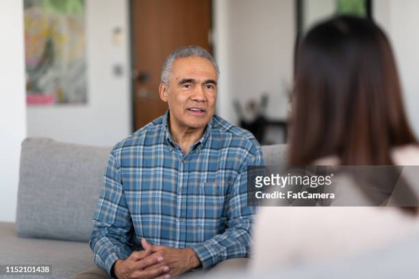 an elderly married man at couple's therapy - psychotherapy stock pictures, royalty-free photos & images