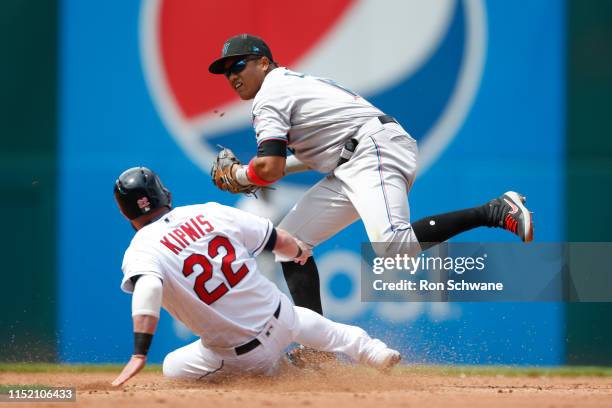 Starlin Castro of the Miami Marlins forces out Jason Kipnis of the Cleveland Indians at second base during the fourth inning at Progressive Field on...
