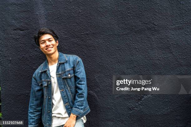 young taiwanese entrepreneur standing in front of his coffee shop - chinese taipei stock-fotos und bilder