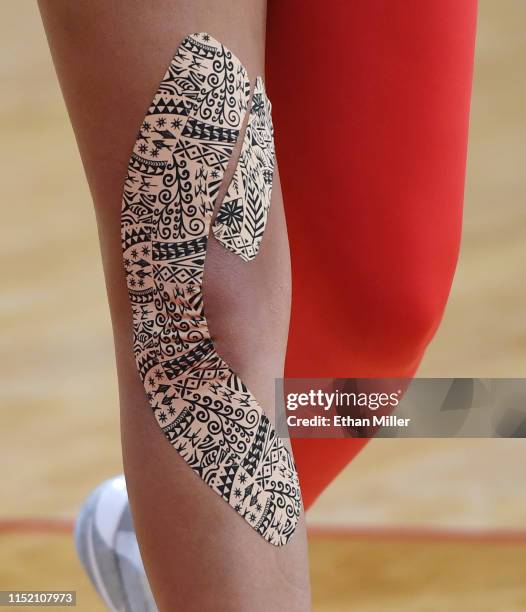 Ja Wilson of the Las Vegas Aces wears kinesiology tape on her right knee as she warms up before a game against the Los Angeles Sparks at the Mandalay...