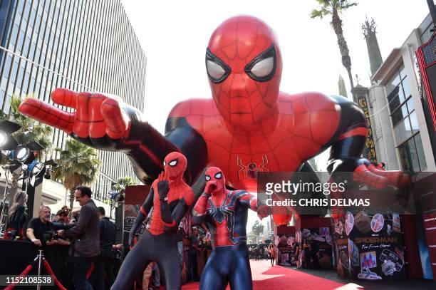 People dressed as Spider-Man pose on the red carpet ahead of the premiere of "Spider-Man: Far From Home" at the TCL Chinese Theatre in Hollywood on...