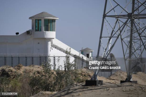 This photo taken on May 31, 2019 shows watchtowers on a high-security facility near what is believed to be a re-education camp where mostly Muslim...