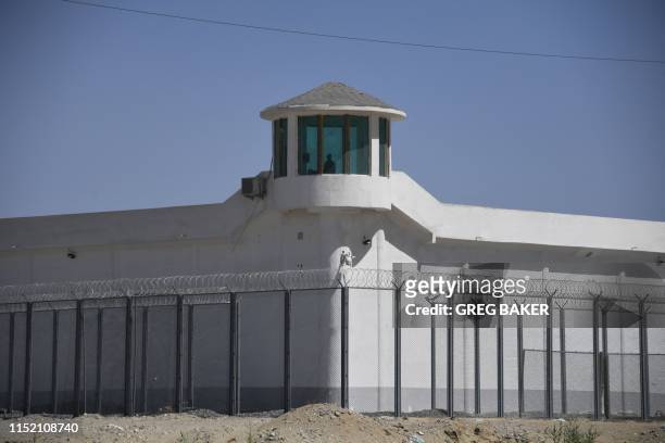 This photo taken on May 31, 2019 shows a watchtower on a high-security facility near what is believed to be a re-education camp where mostly Muslim...