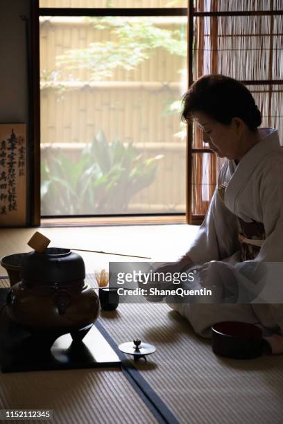 japanese woman holding bowl in tea ceremony - tea ceremony stock pictures, royalty-free photos & images