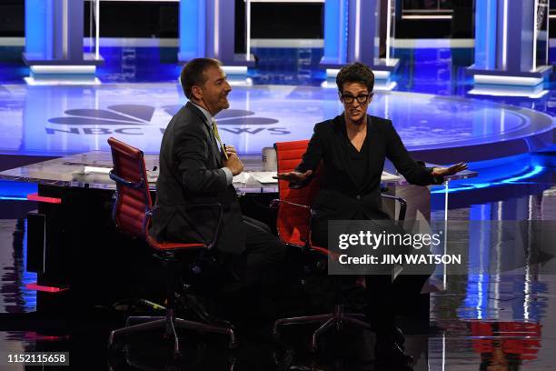 Moderators Chuck Todd and Rachel Maddow speak to audience during a technical problem as they host the first night of the Democratic presidential...