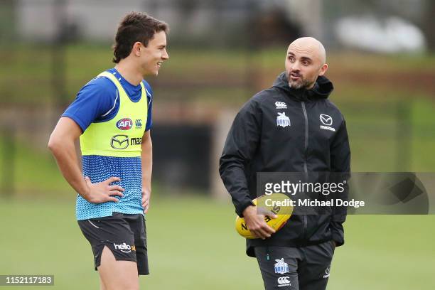 Interim coach Rhyce Shaw talks to Luke Davies-Uniacke of the Kangaroos during a North Melbourne Kangaroos AFL training session at Arden Street Ground...