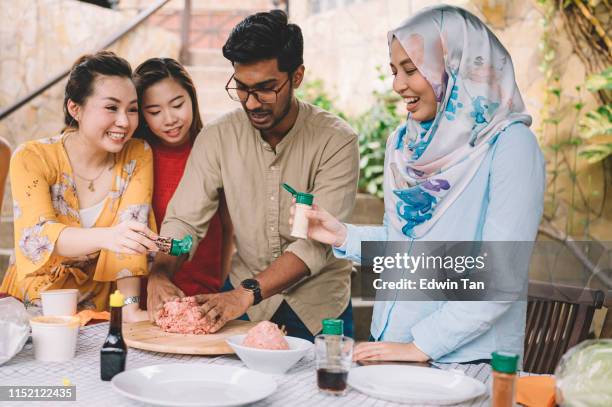 a group of asian multi ethic young adults gathering at villa during weekend for city break enjoying barbecue session and preparing food - malaysian culture stock pictures, royalty-free photos & images