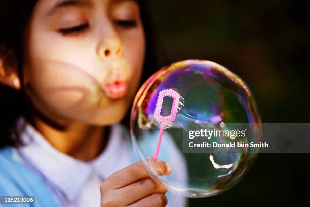 blowing bubbles - bubble wand photos et images de collection