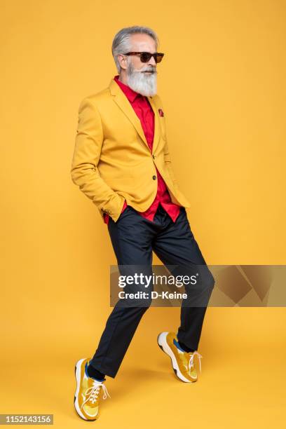 happy well dressed gentleman having photoshooting in studio - multi coloured suit stock pictures, royalty-free photos & images