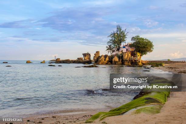 phu quoc island, kien giang province, vietnam - august 22, 2014: dinh cau rock temple in beautiful sunrise (phu quoc island, kien giang, vietnam) - insel phu quoc stock-fotos und bilder